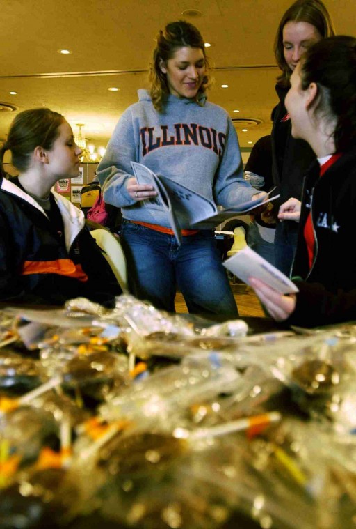 Megan Kough (left to right), freshman in business, Sarah Heuring, freshman in LAS, Jessica Barker, freshman in LAS, and Cambria Wallrich, freshman in engineering, listen to Heuring as she reads from the spring issue of Pandora´s Rag in the Illini Un Tim Eggerding

