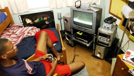 ary Cooper, sophomore in LAS, plays NFL football on his convenience gadget, a five CD/DVD changer with surround sound Tuesday afternoon in his room at Hopkins Hall. Shira Weissman
