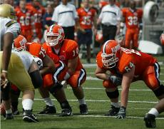 As Illinois quarterback Brad Bower (14) lines up behind Duke Preston (75), left guard Martin O´Donnell (64) waits for the snap during the game against UCLA on Saturday. Online Poster
