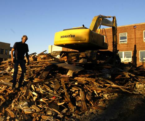 Franzen Constuction employee and St. Joseph resident Aaron Franzen calls it a day at the demolition site where a house that was attached to Austin´s Sporting goods had stood Tuesday at the corner of Fifth and Green streets. Online Poster
