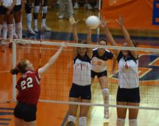 Jessica Belter (1) and Jen Hynds (6) attempt to block an Illinois State spike in Huff Hall on Wednesday. Online Poster
