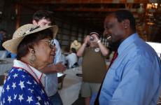 Senate candidate Alan Keyes shakes the hands of Anna Wall Scott, an Urbana resident and professor at Parkland College, during the annual Champaign County Republican picnic on Sunday. Online Poster
