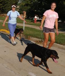 Right to left, Heidi Crawford, senior in ACES, runs with her dog Halo while her mom, Suzy Crawford, follows behind with her companion Mugsy. Online Poster
