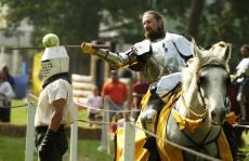 Timothy+Toby+attempts+to+slice+a+cabbage+in+half+as+it+sits+atop+a+volunteer%C2%B4s+head+during+a+jousting+and+skill+competition+Sunday.+Toby+was+part+of+the+Illinois+Renaissance+Faire+at+the+Champaign+County+Fairgrounds.+Tim+Eggerding%0A