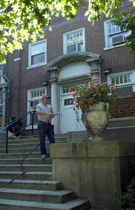 Roy Smith from Campus Facilities and Services waters the flowers outside Coble Hall Monday afternoon. Everything is real dry, Smith said. We need to water the plants constantly, as often as every other day - especially the flowers. Shira Weissman
