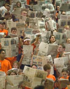 Members of the Spike Squad hold up newspapers while members of the top-ranked USC women´s volleyball team are introduced on Saturday night at Huff Hall. Illinois defeated USC in 5 sets, breaking USC´s record 52-game winning streak. Online Poster
