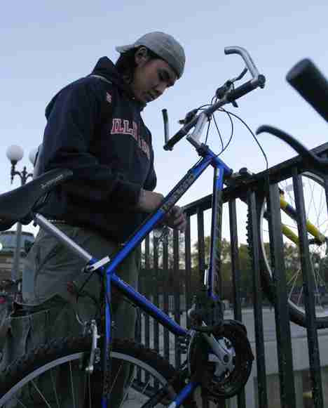 Howard Yu, freshman in LAS, locks up his bike outside of the Undergraduate Library on Tuesday evening. Alex Nowak
