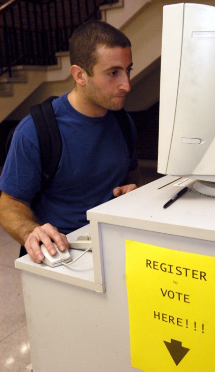 Alex D´Erizans, graduate student, registers to vote at the Undergraduate Library´s lower level on Tuesday. The last day to register to vote is Oct. 5. Online Poster
