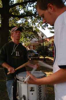 Chris Ham (right) gives Chad Smith, both juniors in engineering and members of the Marching Illini drum line, a lesson in the snare drum outside of the Harding Band Building on Tuesday. Chad has been receiving lessons from Smith since January in hopes of Online Poster
