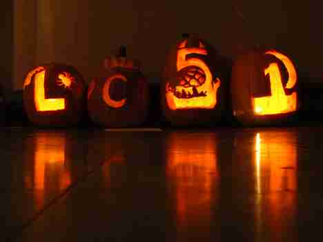 Pumpkins carved by the Learning Community 51 program sit Tuesday evening inside Lincoln Hall. Carved for its annual learning community pumpkin carving contest, the pumpkins were judged on skill and originality. Online Poster

