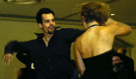 David Klaus and Kaitlin Ainsworth, both from Northwestern University, dance in the Illini Ballroom in the Illini Union during the 16th Annual Dancing Illini Dance Sport Invitational on Saturday. Tim Eggerding
