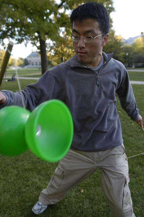 Fred Wu, freshman in LAS, plays with a Chinese yo-yo during a weekly cultural event that is part of the Taiwanese-American Student Club cultural committee on the Quad, Saturday. Wu said, "The Chinese yo-yo is a good way to pick up girls." Tim Eggerding
