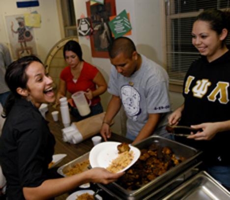 Piece of Puerto Rico Carol Matteucci The Daily Illini From right: Claudia Arteaga, sophomore in ACES, and Jose Diaz, senior in LAS serve Puertorican food to Vanessa Torres, sophomore in LAS, while Andrea Vasco, junior in business, poors pina coladas in the background Monday night at La Casa Cultural Latina. La Casa and Puerto Rican Student Association put on the Taste of Puerto Rico.
