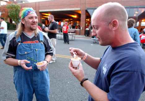Mahomet resident Brian Stabler, right, and Urbana resident Drew Rennick talk over a sample of Spicy Vegan Chili from the Canopy Club Booth at the Chili and Beer Cookoff in downtown Urbana on Saturday. Online Poster
