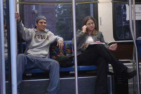 Carlos Lopez, freshman in LAS, left, and Gwynne Rowe, sophomore in communications, wait on the bus as the driver takes a quick break at a stop on Gregory Drive outside the six pack on Tuesday evening Alex Nowak
