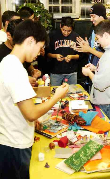 Dia de Los Muertos Carol Matteucci The Daily Illini Students make crafts for Dia de Los Muertos "The Day of the Dead" sponsered by La Casa, Mexican Students Association, and the Illini Union Board at La Casa Cultural Latina Monday night. Allen Tran, far left, sophomore in LAS, is sculpting a rose and skull in commemoration of the holiday.
