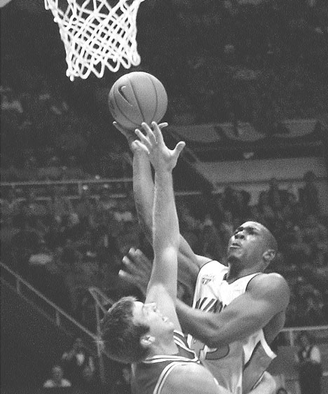 Illinois forward Roger Powell (43) makes a layup over SIU-Edwardsville´s Tim Bauersachs (33) on Nov. 5 at Assembly Hall. Illinois won 78-58. Online Poster
