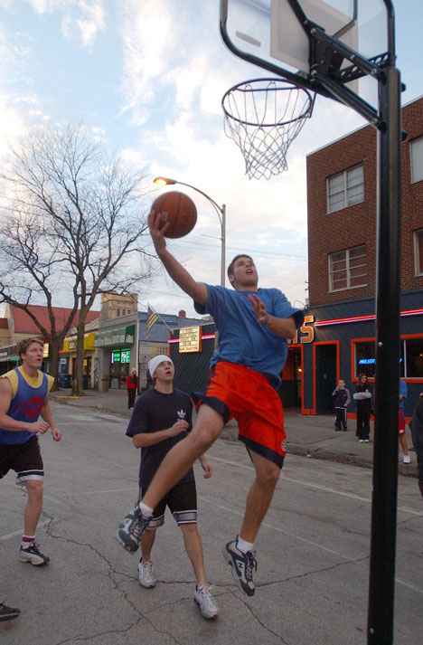 Brandon Murphy, sophomore in business, makes a layup on Sunday in the championship round of the 2004 Theta Hoops, an annual street basketball tournament held on Daniel Street by Kappa Alpha Theta to raise money for charitable organizations. Online Poster

