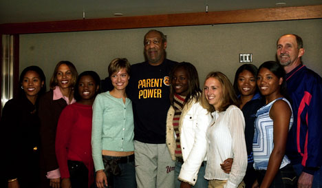 Bill Cosby poses for pictures with members of the women´s track team Saturday night at a meet-and-greet in Assembly Hall before his performance.Bill Cosby poses for pictures with members of the women´s track team Saturday night at a meet-and-g Online Poster
