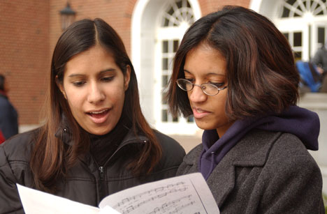 Juniors in LAS Ami Mehta, left, and Monica Natarajan sing during the Guys n´ Dolls a cappella group fundraiser bake sale Monday on the Quad. Guys n´ Dolls is a co-ed a cappella group that formed in September. Online Poster
