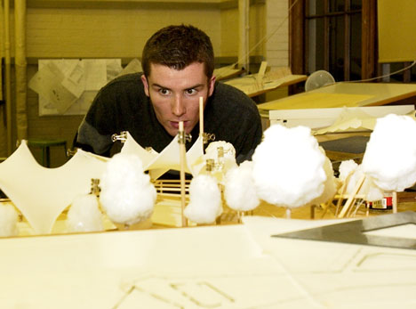 Ben Sheehan, junior in FAA, examines his design studio work of a model for Kickapoo State Park on Monday night in the Architecture Building. Online Poster
