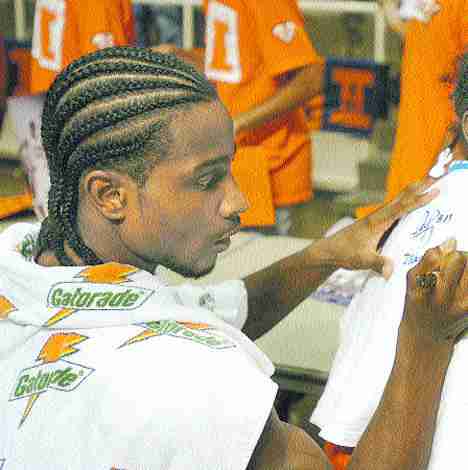 Illinois guard Dee Brown signs a T-shirt Saturday for Aequilla Brown, 8, after the Orange &amp; Blue Scrimmage at Assembly Hall. When asked who her favorite player was, Aequilla answered, "Dee Brown." When asked why, she said, "because he´s my uncle." Online Poster
