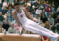 Ted Brown does circles on the pommel horse at the mixed pairs competition Friday at Huff Hall. The Illinois men´s and women´s gymnastics teams combined members to compete against one another to start their season. Online Poster
