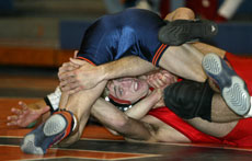 Illinois´ Brian Glynn attempts to pin Central Missouri State´s Kevin Grece during their match Saturday at Huff Hall. Online Poster

