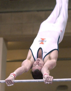 Illinois´ Adam Pummer competes on the high bar Friday at the Mixed Pairs meet at Huff Hall. Online Poster
