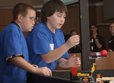 Brothers Sam Porter, ll, left, and Rudy Porter, 13, of team Android 005, compete with their Lego robot at the FIRST Lego League Regional Competition held Saturday at the Siebel Center. Online Poster
