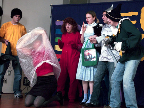 In a scene of the ´Wizard of AIDS´ (from left to right) Ben Osbun as a Munchkin, Aaron Caponigro as The Lion, Katie Hammond as Dorothy, Armand Vasquez as The Tin Man, and John Sessler as The Scarecrow watch in horror as Kate Berry playing the Online Poster
