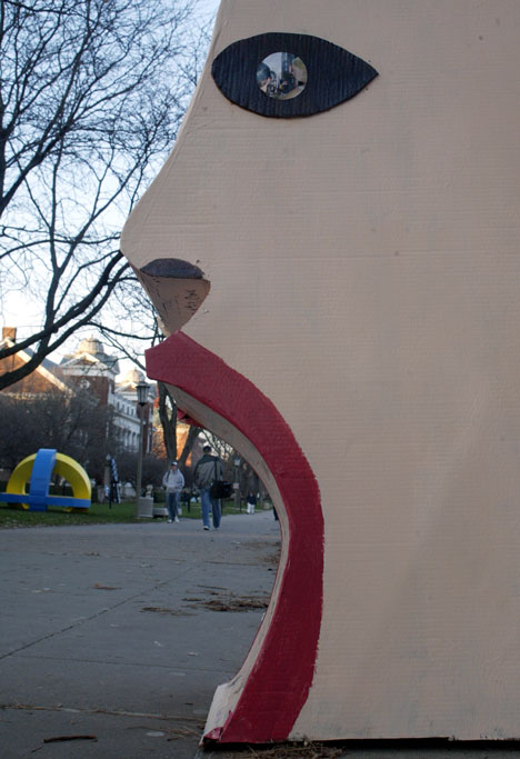 As students walk on the Quad, the sculpture "Stranger" - designed by Carrie Vlcek - stands on Thursday by Foellinger Auditorium. More than a dozen sculptures from ArtGP 305, Art for Public Places, were scattered on Thurs. around the Quad. Online Poster
