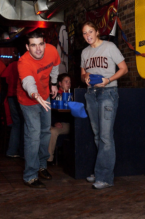 Graduate student Barry Whalen plays a game of Bags for Illinois basketball tickets during the WPGU pre-game at Kam´s. "I come out to Kam´s before every game to get our drink on and to get a free ride to the game," he said. Tim Eggerding
