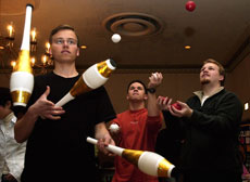 Thorsten Schult, exchange student in LAS, Joe Miksan, freshman in engineering, and Ben Lawrence, graduate student, perform Thursday at the booth for the Illini Juggling and Unicycle Club during Activity Day. Tim Eggerding
