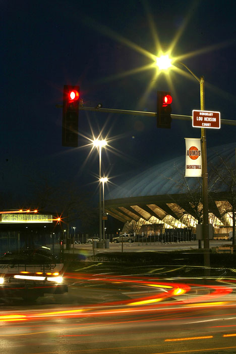 Cars pass by the intersection of First Street and Kirby Avenue on Thursday night. First Street, between Kirby Avenue and St. Mary´s Road, now features new honorary street signs designating the street as Lou Henson Court. Henson, a former Illinois c Tim Eggerding
