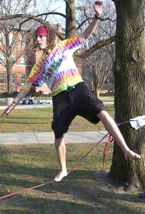 Clay Carz, freshman in LAS, tries to maintain balance on a skyline stretched between trees Thursday afternoon on the Quad. Tessa Pelias
