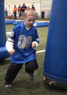 Paul Zilewicz, 5, runs the obstacle course during Football Family Fun Fest on Saturday at the Irwin Indoor Practice Facility. Online Poster
