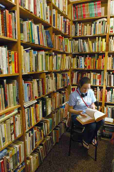 Freshman in LAS Celia Voyles shops in the Jane Addams Book Shop, 208 N. Neil St., Champaign. Voyles was looking for a birthday present for her friend. Online Poster
