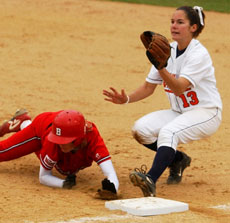 Bradley freshman Molly Bergeson dives back to first base to beat the tag of Illinois´ Molly Lawhead, sophomore, during the first game at Eichelberger Field, April 21. The second in the double-header was canceled due to rain, but Illinois won the fir Online Poster
