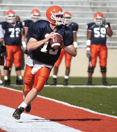 Illinois quarterback Chris Pazan looks for someone to throw to at the football scrimmage held at Memorial Stadium on Saturday. Online Poster
