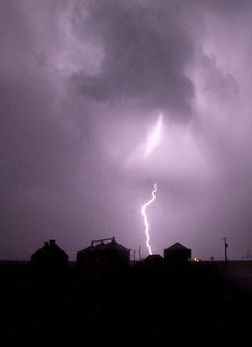 Lightning crashes behind a farm in Mahomet on Wednesday night. The series of storms that blew through Illinois dropped four tornadoes across the state with winds in excess of 80 mph. Troy Stanger
