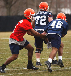 Kisan Flakes, a redshirt freshman quarterback, fakes a handoff at the Illinois football team´s first practice on March 30 at the practice field next to Memorial Stadium. Online Poster
