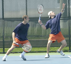 Illinois senior Chris Martin prepares to hit an overhead as senior Conner Murninghan moves into a defensive position on Sunday against Wisconsin at the Atkins Tennis Center. Online Poster
