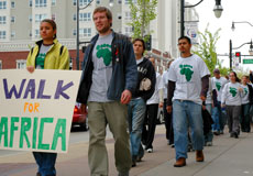 Amanda Moore, freshman in LAS, and graduate student Matt Sweeney lead the walk for Africa down Green Street on Saturday. Online Poster
