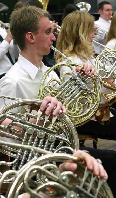 Mike Kasper, freshman in LAS, tunes and warms up his French horn with the Concert Band I before performing at the Krannert Center for the Performing Arts on Sunday afternoon. Later, the Symphonic Band II played. Online Poster
