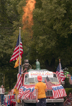 The Ralph and Joe Flying Tomato Brothers float spouts fire in the midst of the Fourth of July parade on Monday in Urbana. Online Poster
