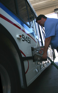 Don Pittman, maintenance worker for the Champaign-Urbana Mass Transit District, fuels a bus Wednesday at the maintenance facility at 803 E. University Ave., Urbana. Director of Maintenance David Moore said that the MTD´s cost of diesel fuel has pro Online Poster
