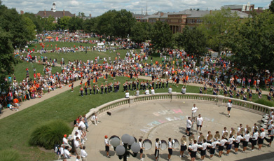 Students gather on the Quad Tuesday to find out about student clubs and watch the performance put on by the Marching Illini, Illinois Cheerleaders, Poms and Color Guard. Online Poster
