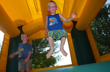Champaign residents Jake (left) and Dale Robbennolt, 6, jump around one of the play spaces available for children at the art festival in Westside Park Sunday. Their grandmother, Nana, said they came out for some fun and thought it would be a good way to Online Poster
