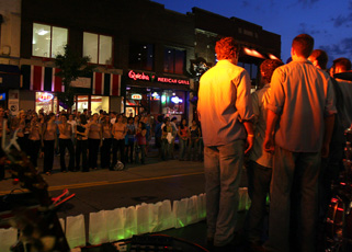 The X-tension Chords, an all-male a cappella group, at right, preforms on Green St. between Wright and Sixth at the Paint Green Street Purple fundraising event on Thursday night. Troy Stanger

